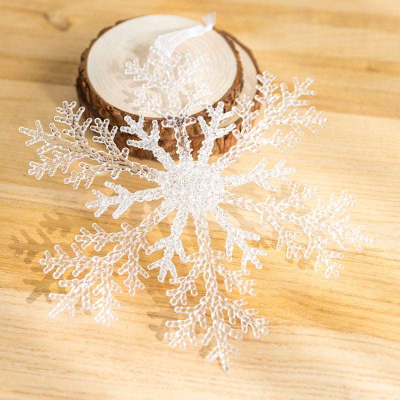 Acrylic Snowflake Christmas Decorations Transparent Tree Pendants hanging on a snowy Christmas tree. Ideal for DIY holiday decor and winter themes.