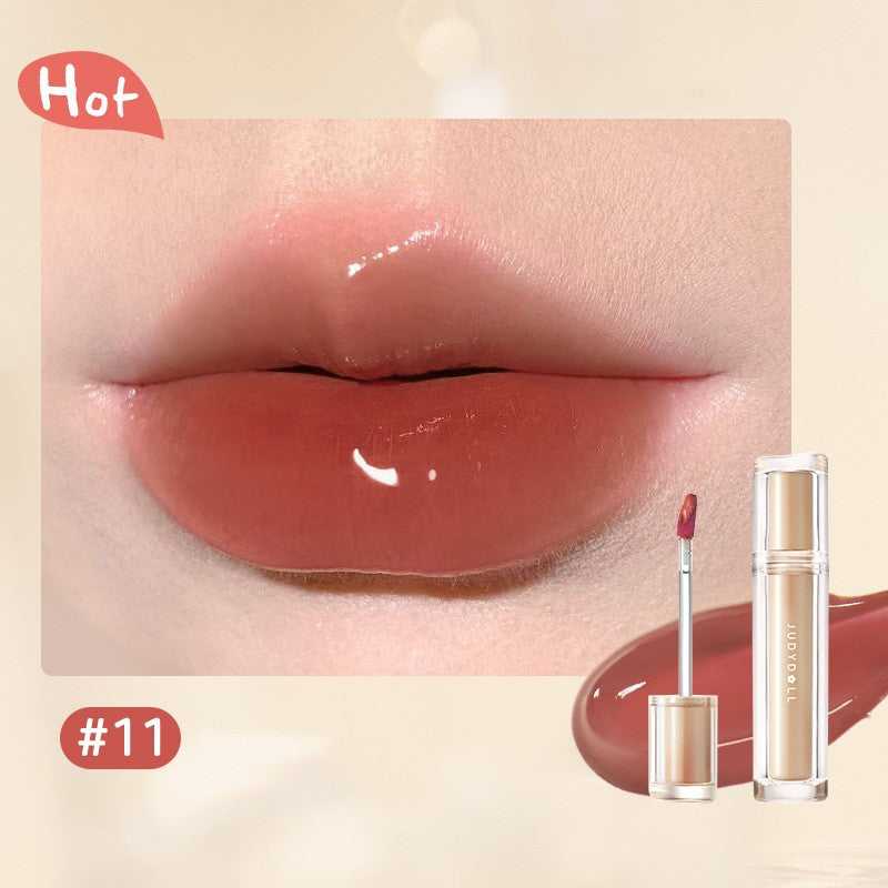 Iced Tea Mirror Lip Gloss Glassy Brown Jelly Lipstick Shine in four shades: Citrus, Brown, Violet, and Peach. Sleek tubes with glossy finish.