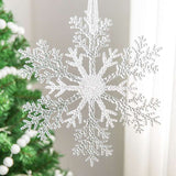 Acrylic Snowflake Christmas Decorations Transparent Tree Pendants hanging on a snowy Christmas tree. Ideal for DIY holiday decor and winter themes.