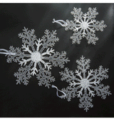 Acrylic Snowflake Christmas Decorations Transparent Tree Pendants hanging on a snowy Christmas tree. Ideal for DIY holiday decor and winter themes.